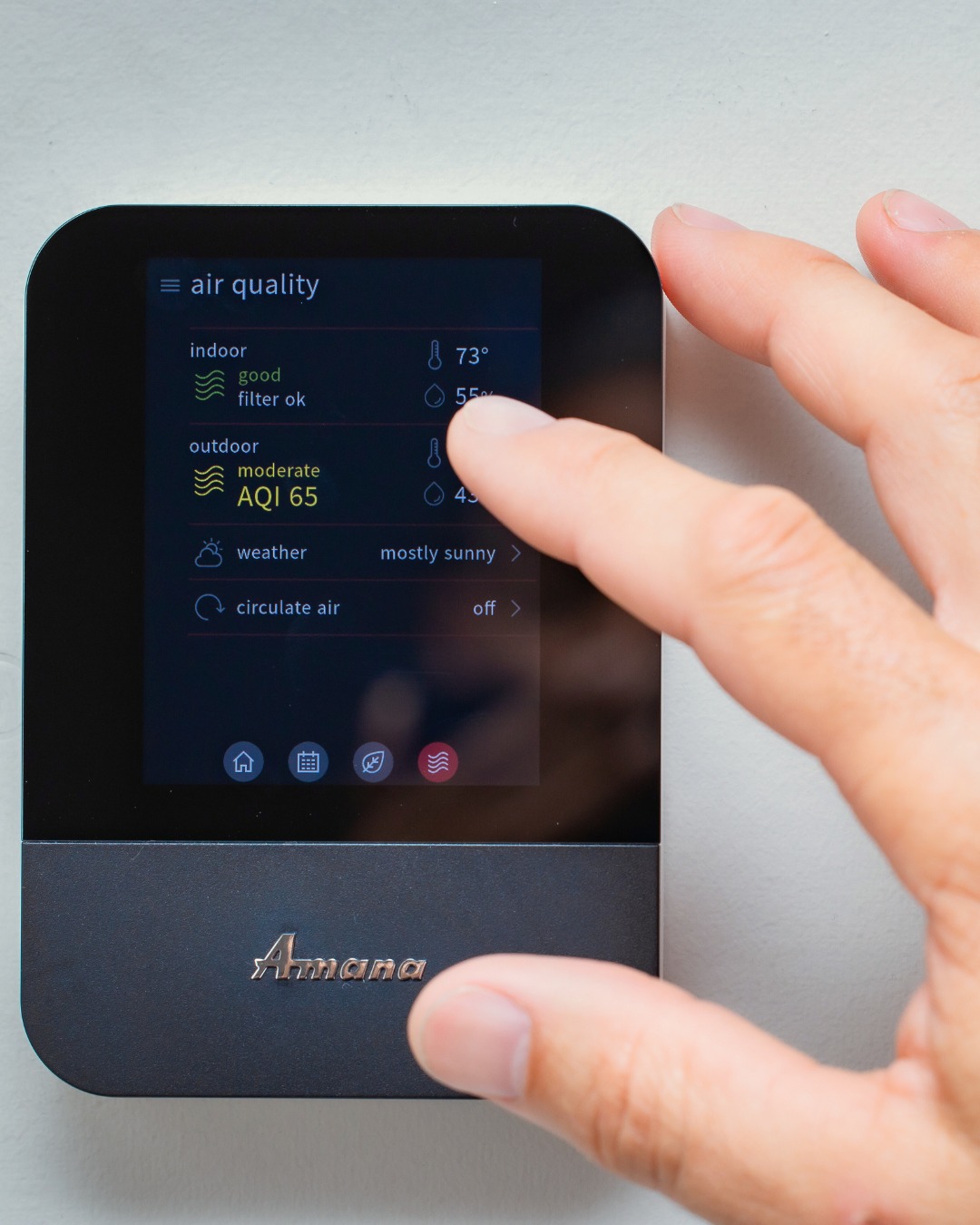 closeup image of an Amana smart thermostat against a wall