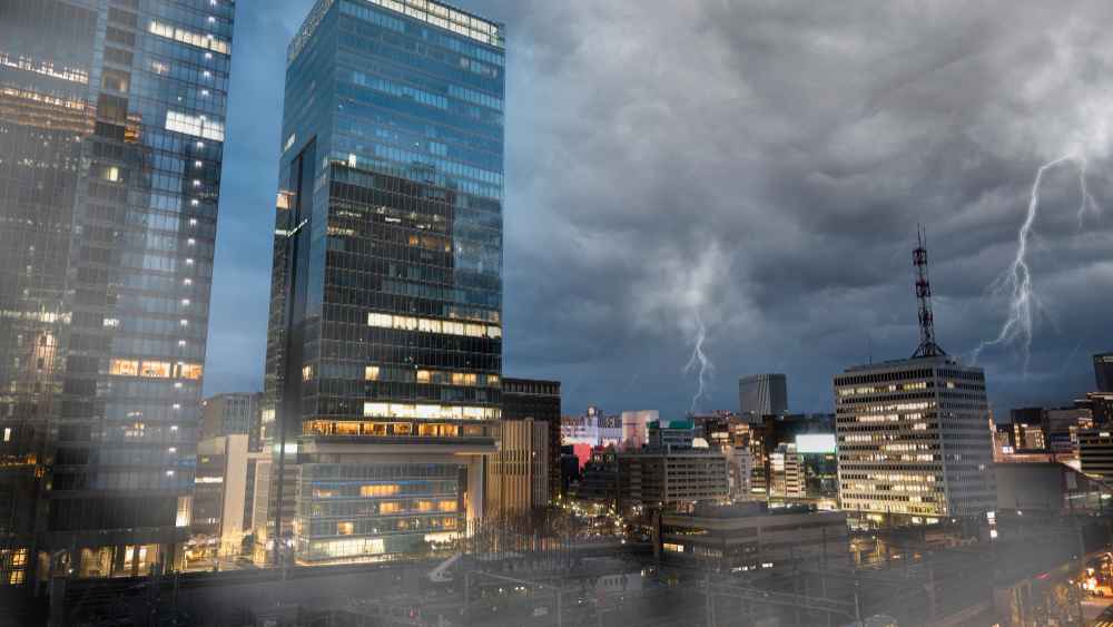 a city skyline at night with lightining and rain during a hurricane season