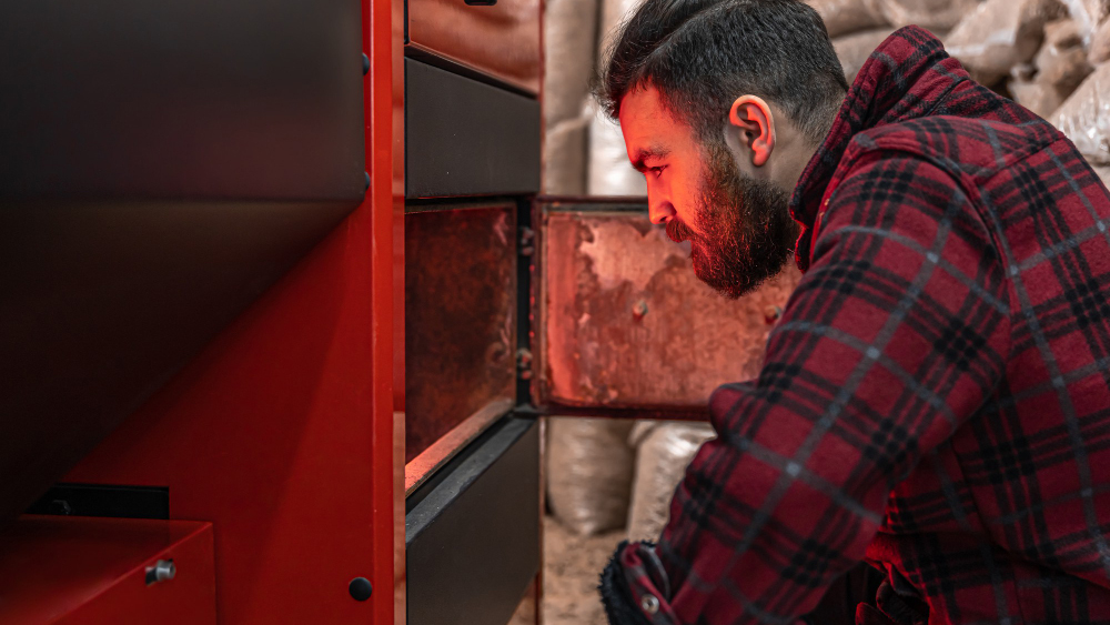 Technician inspecting a furnace, illustrating “how long does a furnace last”.